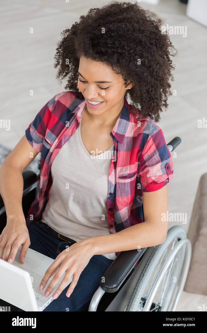 young woman on the wheelchair happy using a laptop Stock Photo - Alamy