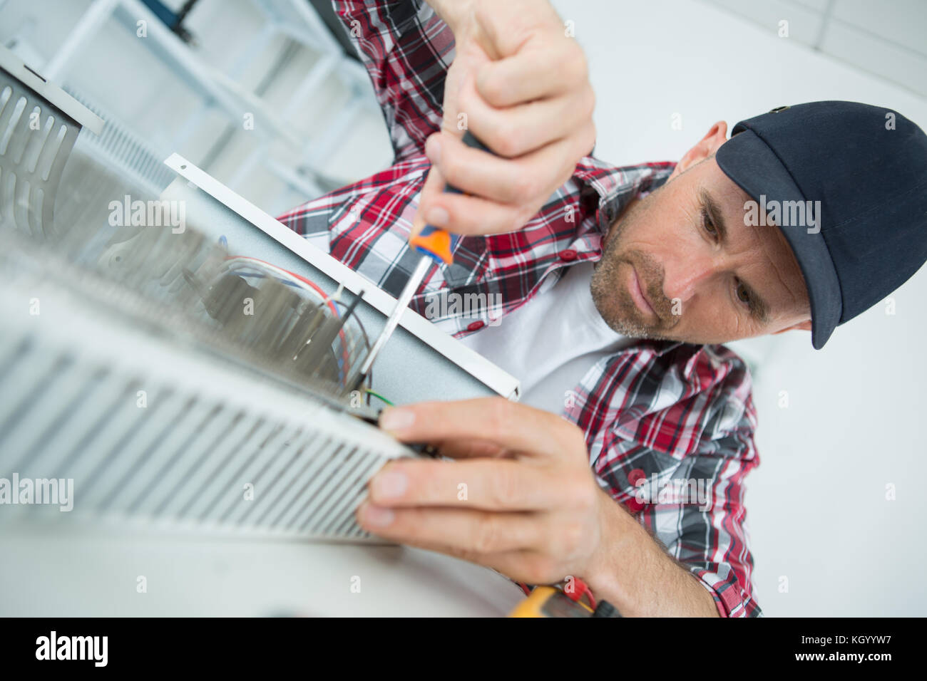 young man repairing radiator Stock Photo Alamy