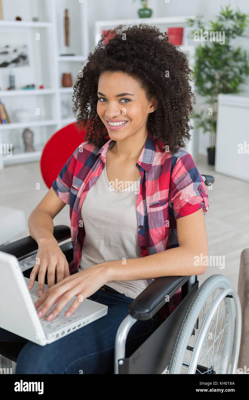 happy women in wheelchair using laptop Stock Photo - Alamy