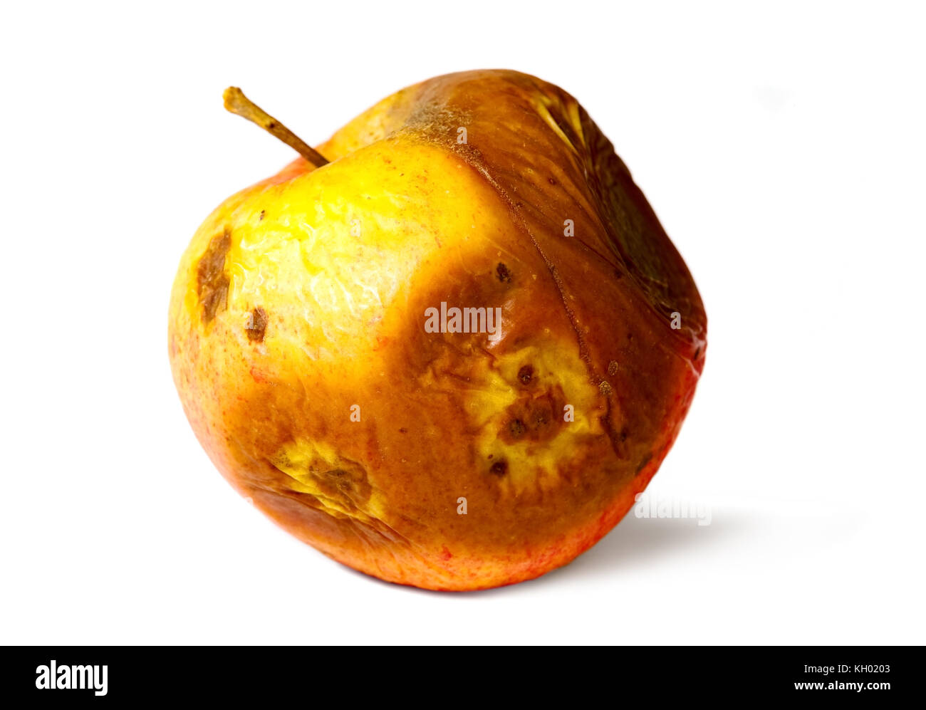 Old rotten apple on white isolated background, unhealthy to eat Stock Photo
