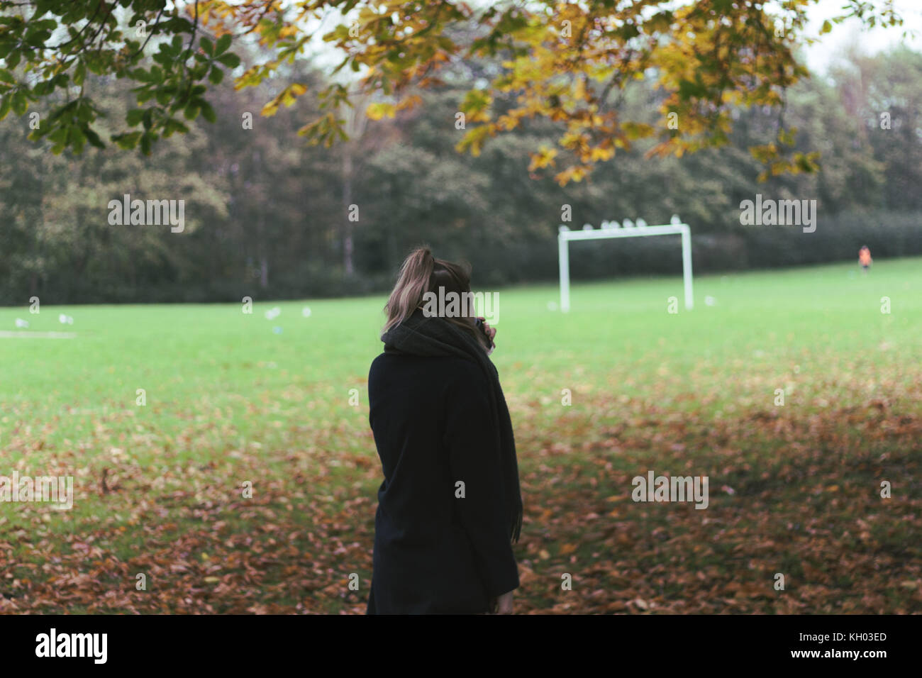 woman walking through the park in autumn Stock Photo - Alamy