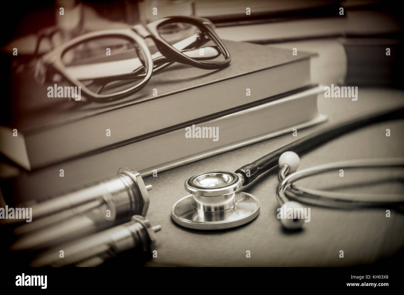 https://c8.alamy.com/comp/KH03X8/medicine-books-next-to-syringes-vintage-and-stethoscope-concept-of-KH03X8.jpg