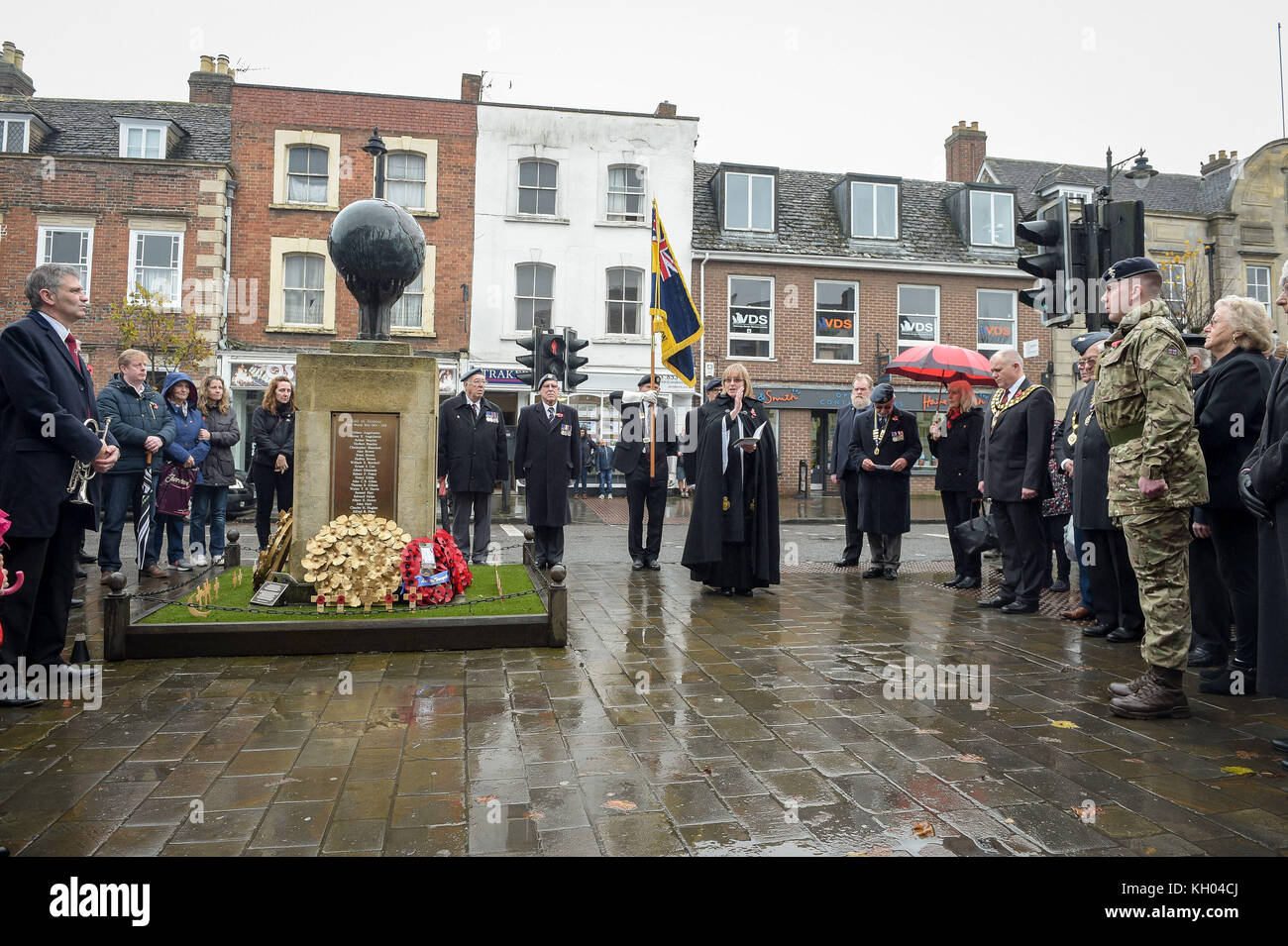 People stand at the war memorial during the remembrance service at
