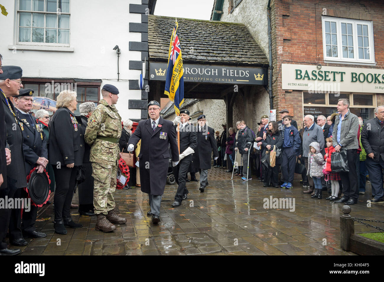Royal British Legion standard bearers march to the war memorial during