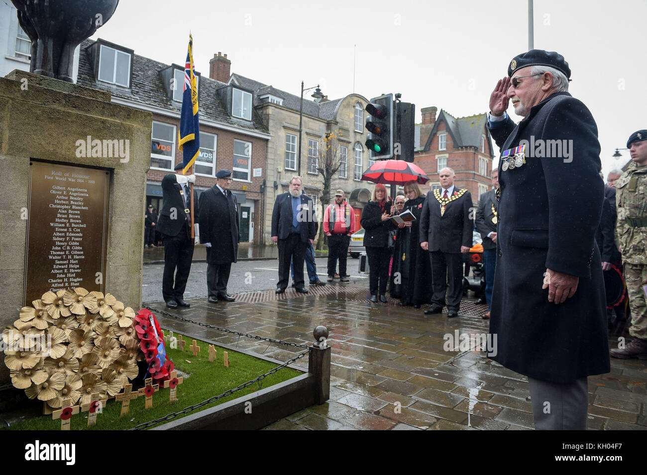 A member of the Royal British Legion salutes after laying a wreath at