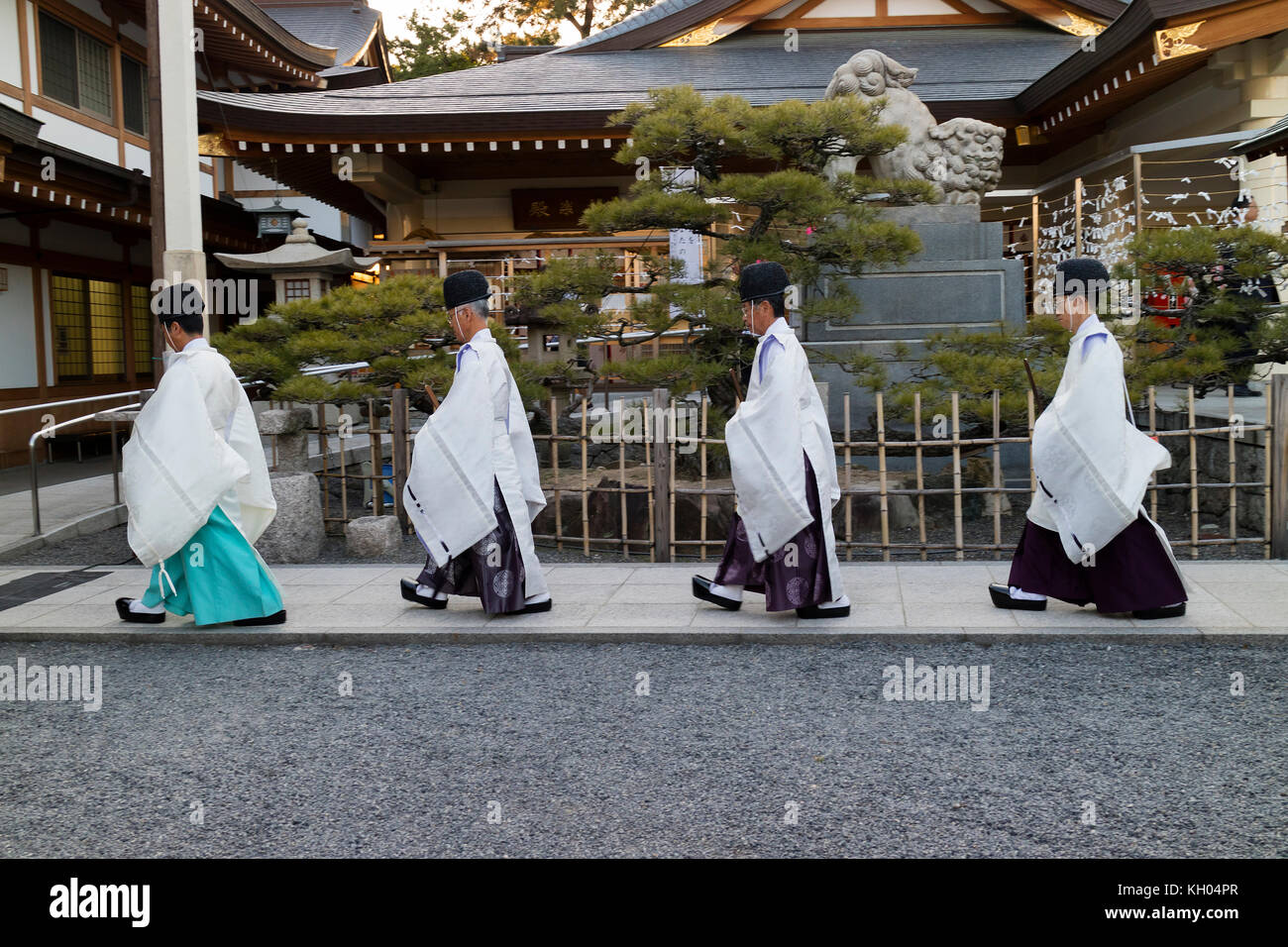 Hiroshima, Japan -  May 27, 2017: Priests in traditional clothes passing at the Hiroshima Gokoku-jinja Shrine Stock Photo