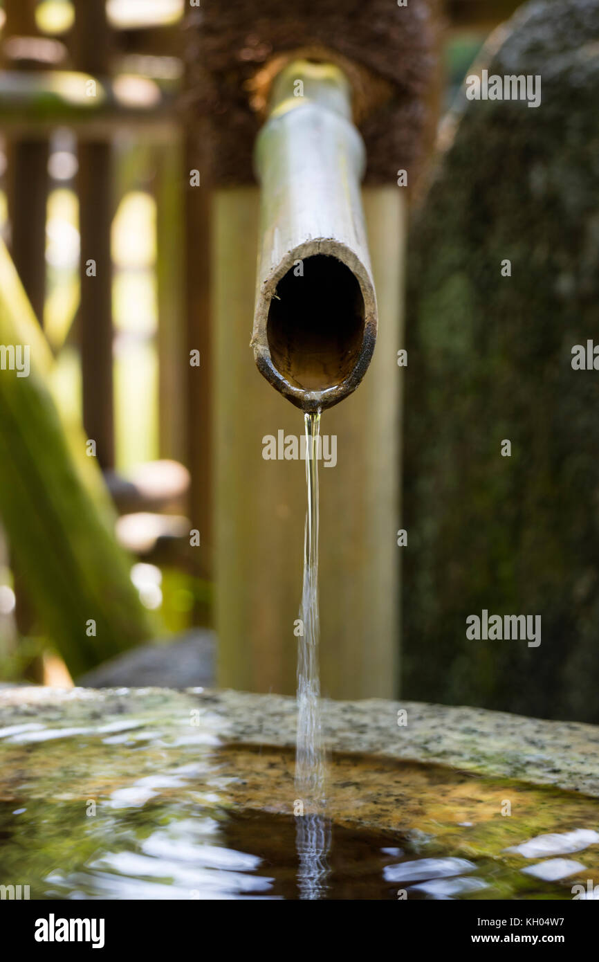 Nara, Japan -  May 29, 2017: Close up of a traditional bamboo water pipe near the temple to clean your hands and mouth Stock Photo