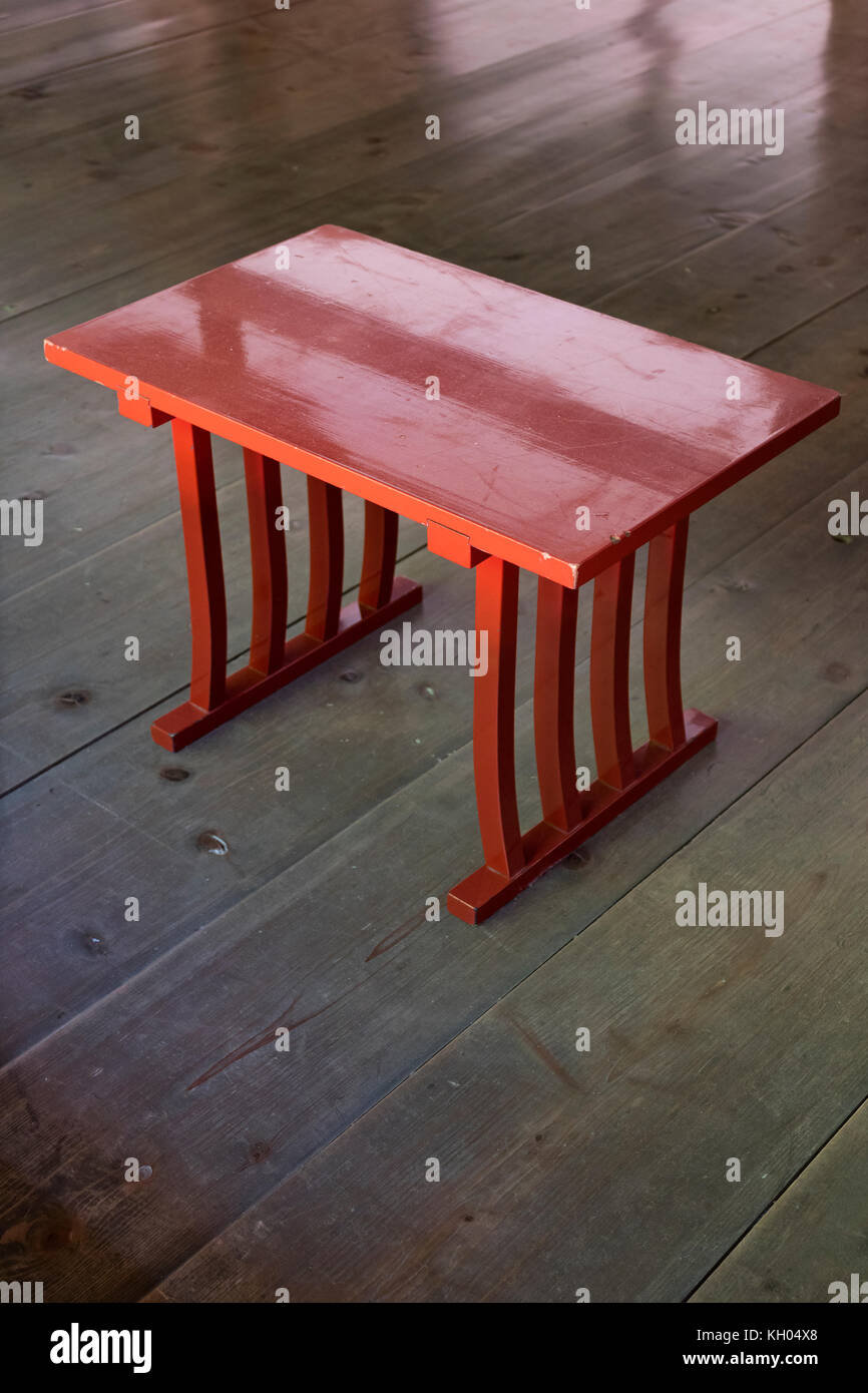 Nara - Japan, May 29, 2017: Traditional designed red painted table on a shiny wooden floor Stock Photo