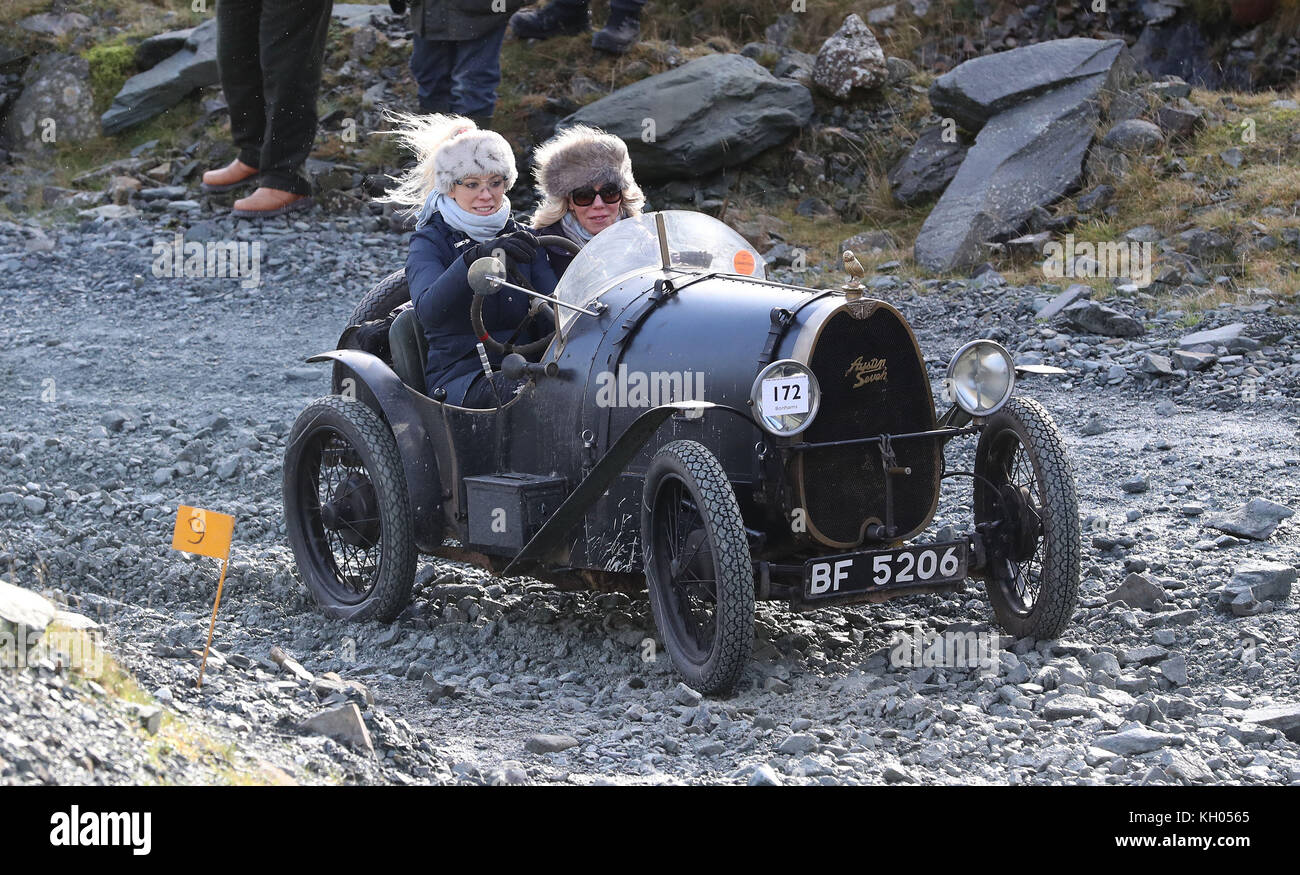 A 1930 Austin 7 driven by Rachael Williams, 34, from Shropshire with her mum Val Williams 65, is driven along the quarry road at Honister Slate Mine, in Borrowdale, Keswick, Cumbria, during the annual Lakeland Trials vintage car rally. Stock Photo