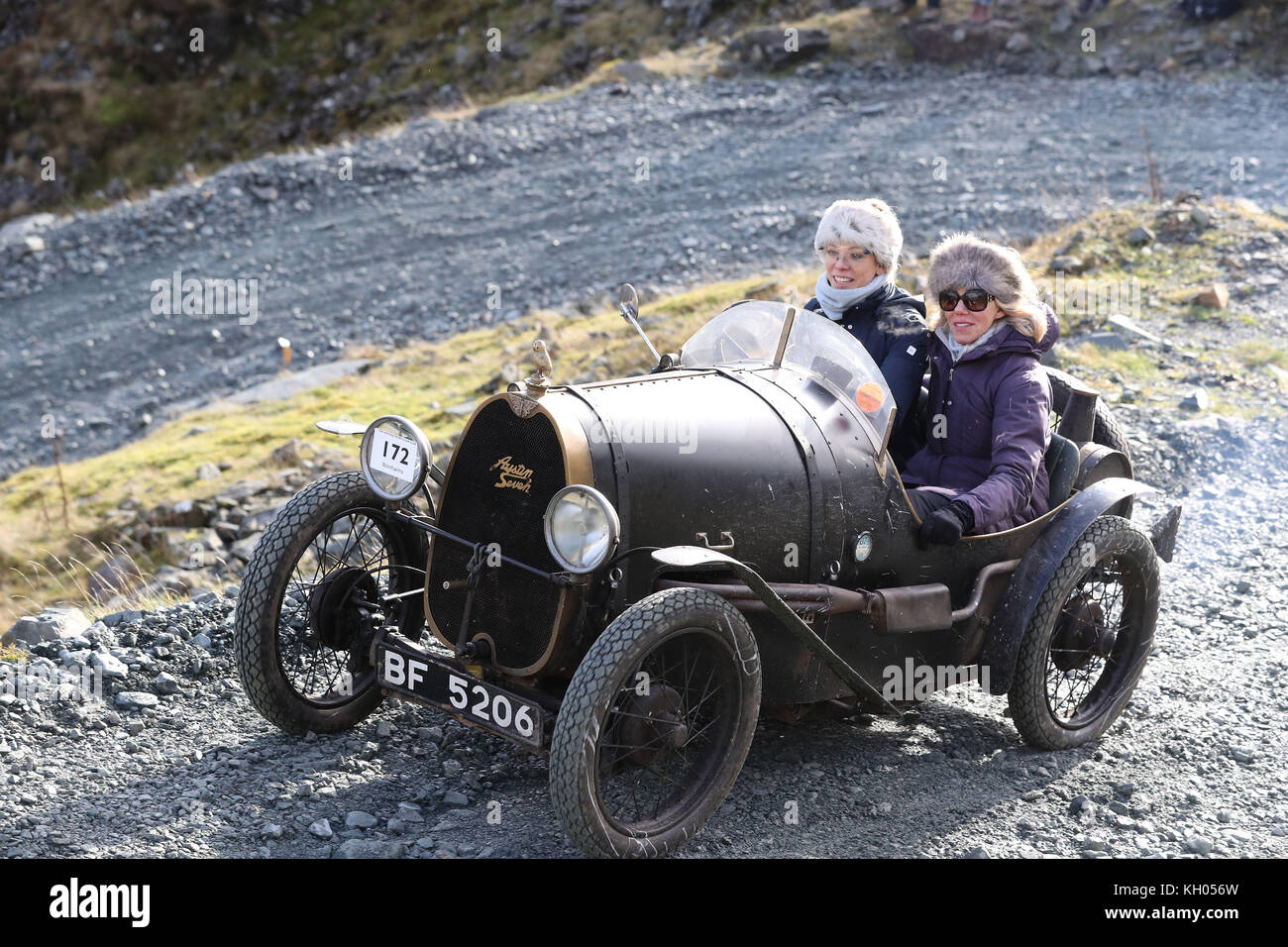 A 1930 Austin 7 driven by Rachael Williams, 34, from Shropshire with her mum Val Williams 65, is driven along the quarry road at Honister Slate Mine, in Borrowdale, Keswick, Cumbria, during the annual Lakeland Trials vintage car rally. Stock Photo
