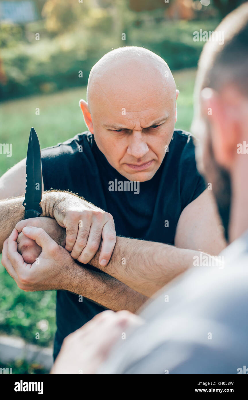Kapap instructor demonstrates martial arts self defense knife attack