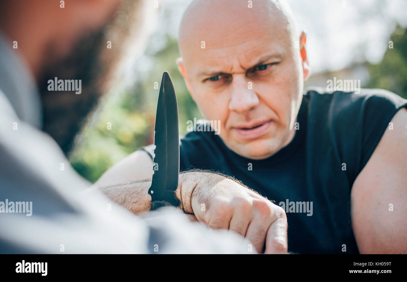 Kapap instructor demonstrates martial arts self defense knife attack