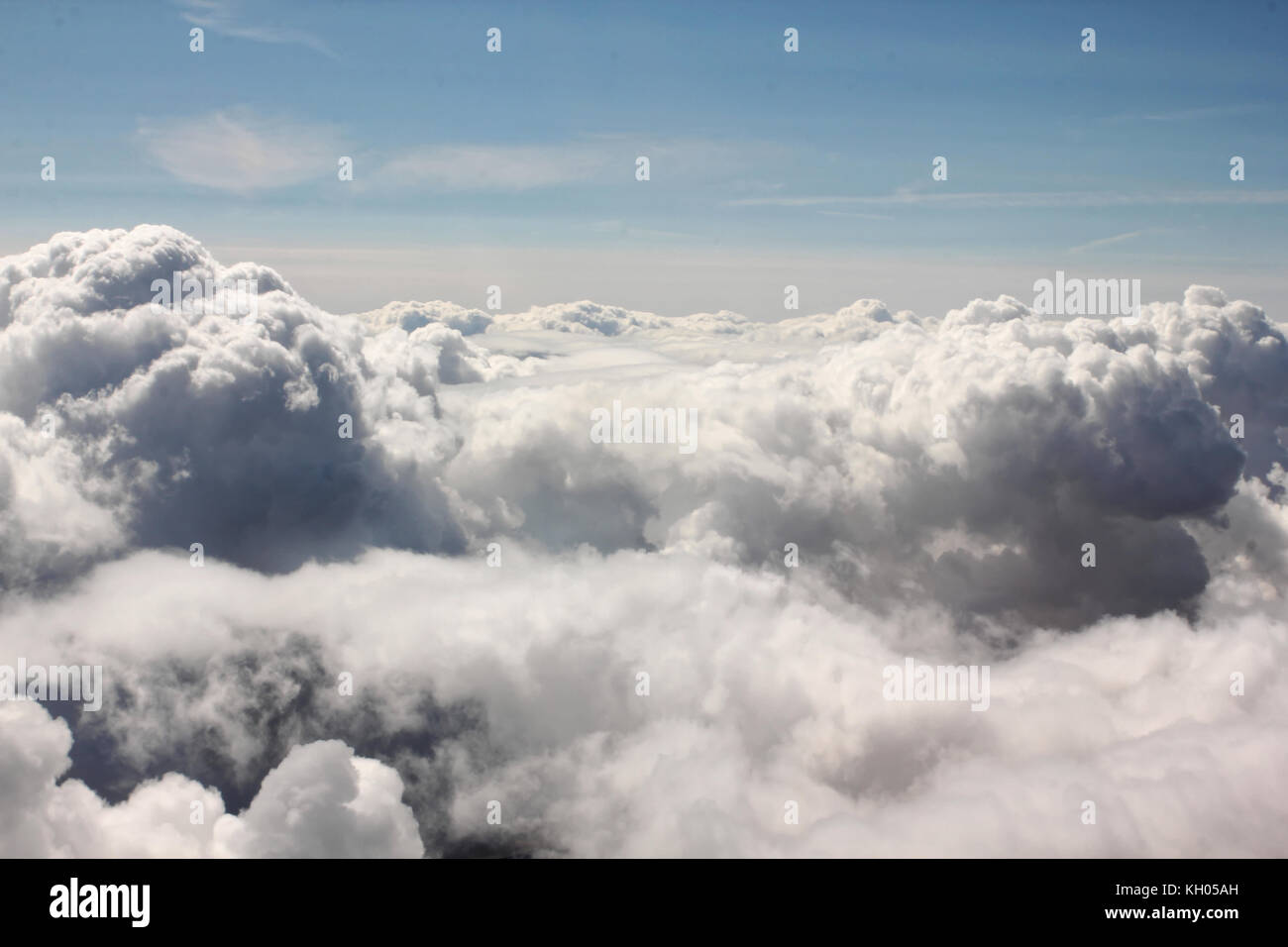 Above the sky. Flying over clouds in plane Stock Photo - Alamy