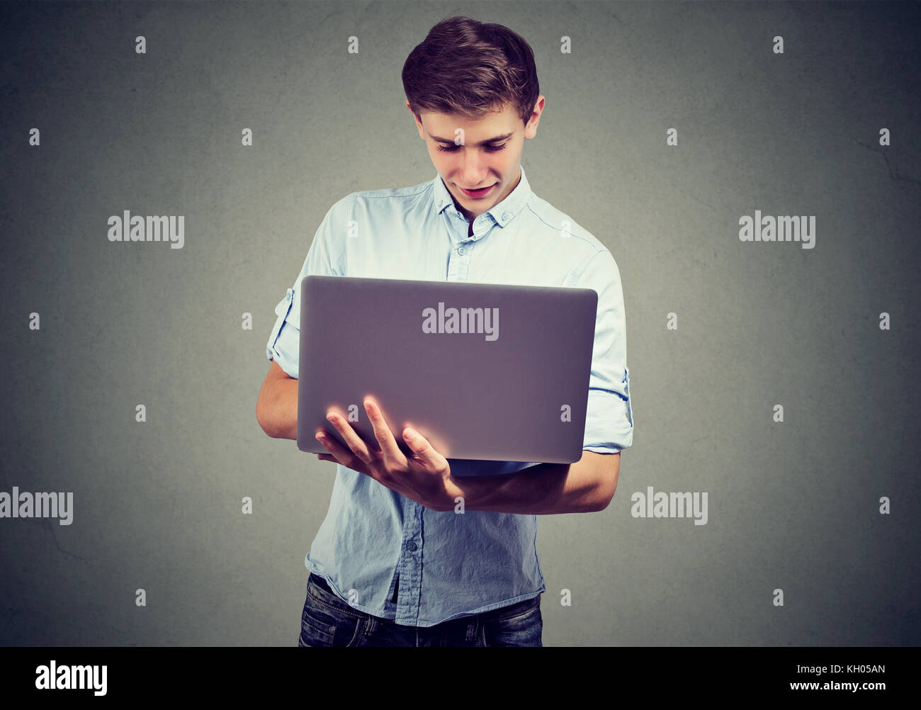 Man using his laptop computer Stock Photo - Alamy