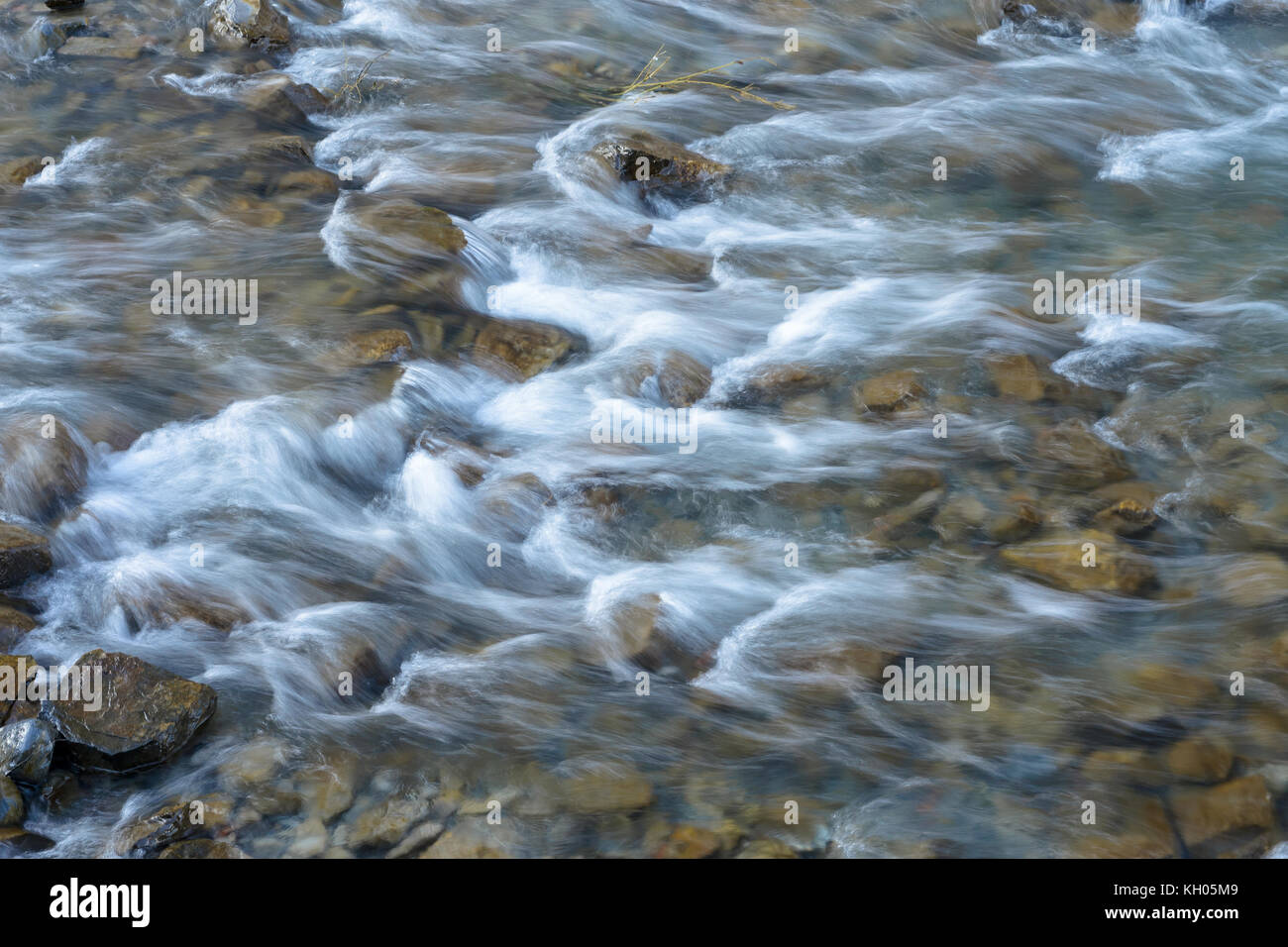 water flowing into a stream, long exposure, moving water effect Stock Photo