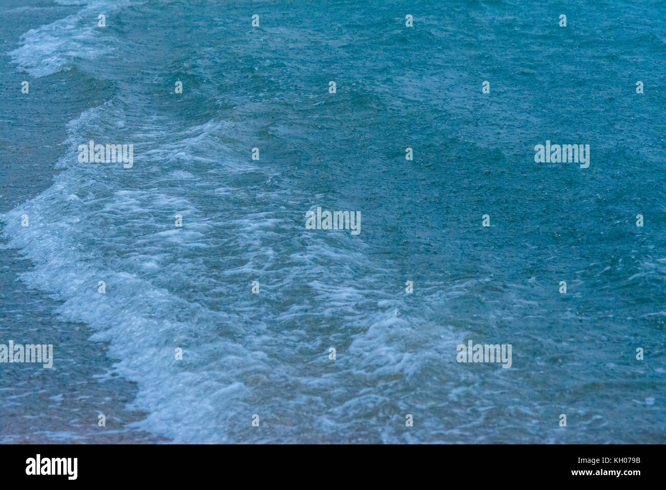 large raindrops falling on the sea during a strong thunderstorm on the Mediterranean Sea Stock Photo
