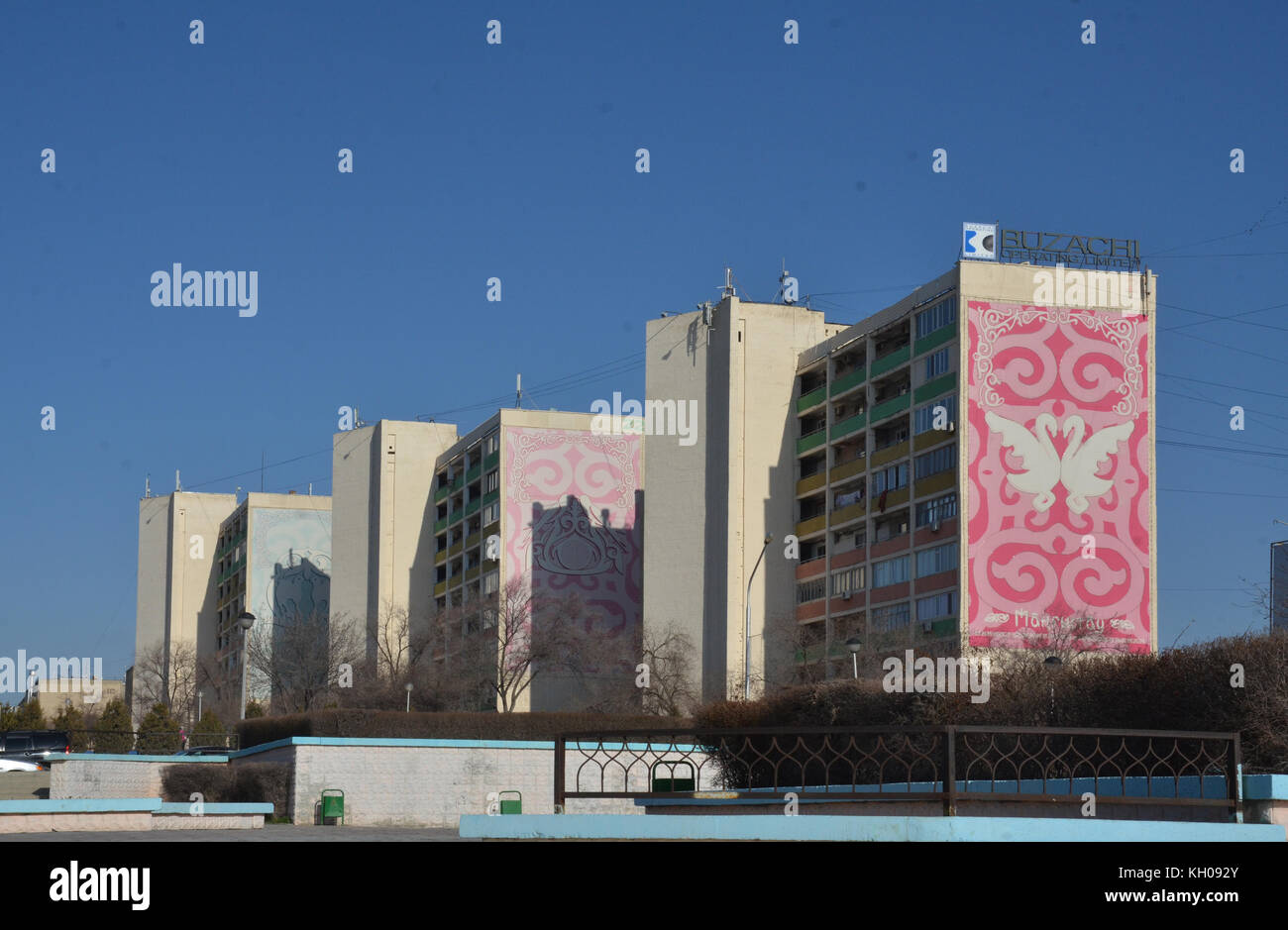 old low cost, colorful decorated with kitsch love swans, soviet union style Khrushchyovka apartment building, numbered, in Aktau, Kazakhstan. Stock Photo
