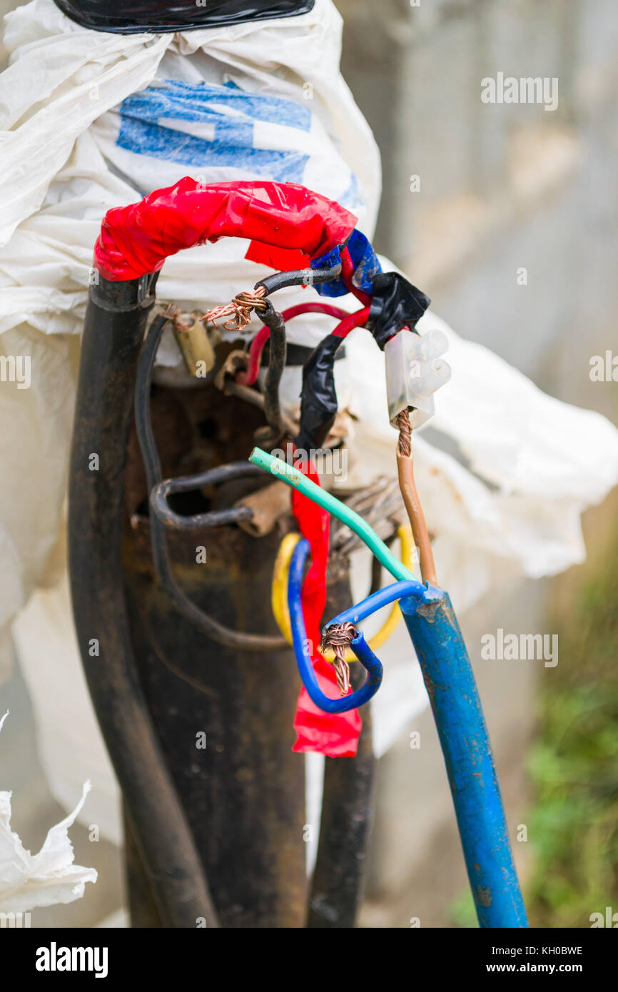 Exposed haphazard electrical cables presenting a potential danger to people, Kenya, East Africa Stock Photo