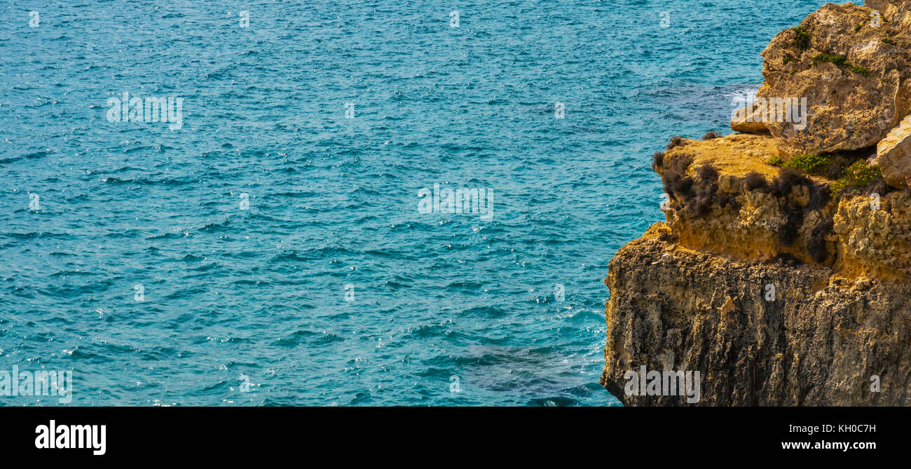 high cliff above the sea, summer sea background, many splashing waves
