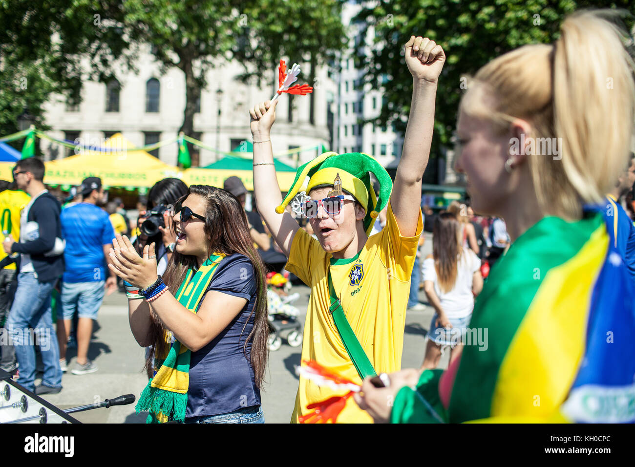 Two Brazilians kill the waiting time playing table footbaal and warm up for the FIFA World Cup at ’Brazil Day’ at Trafalgar Square in London. It looks like we have a winner. UK 12/06 2014. Stock Photo