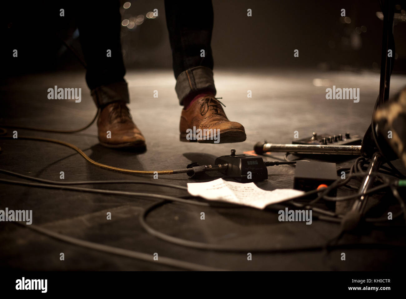 A musician on stage turns on the effect units live in stage at a live