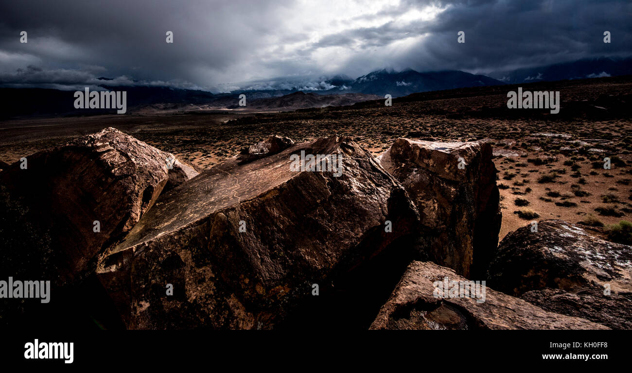 Sky Rock, a skyward facing series of petroglyphs left by the Paiute-Shoshone Indians thousands of years ago, sits before the Sierra Nevada mountains. Stock Photo