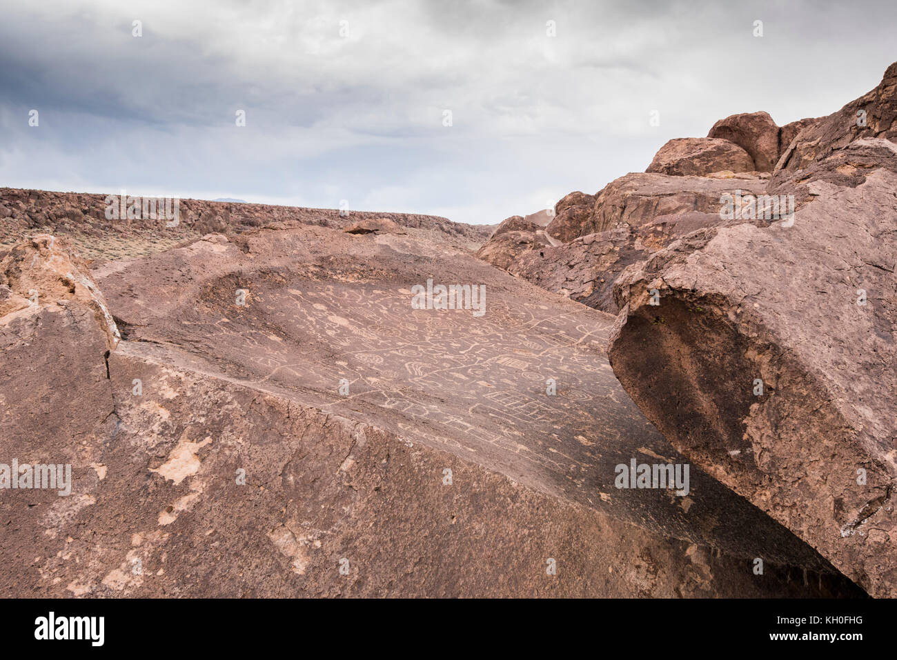 Sky Rock, a skyward facing series of petroglyphs left by the Paiute-Shoshone Indians thousands of years ago, sits before the Sierra Nevada mountains. Stock Photo