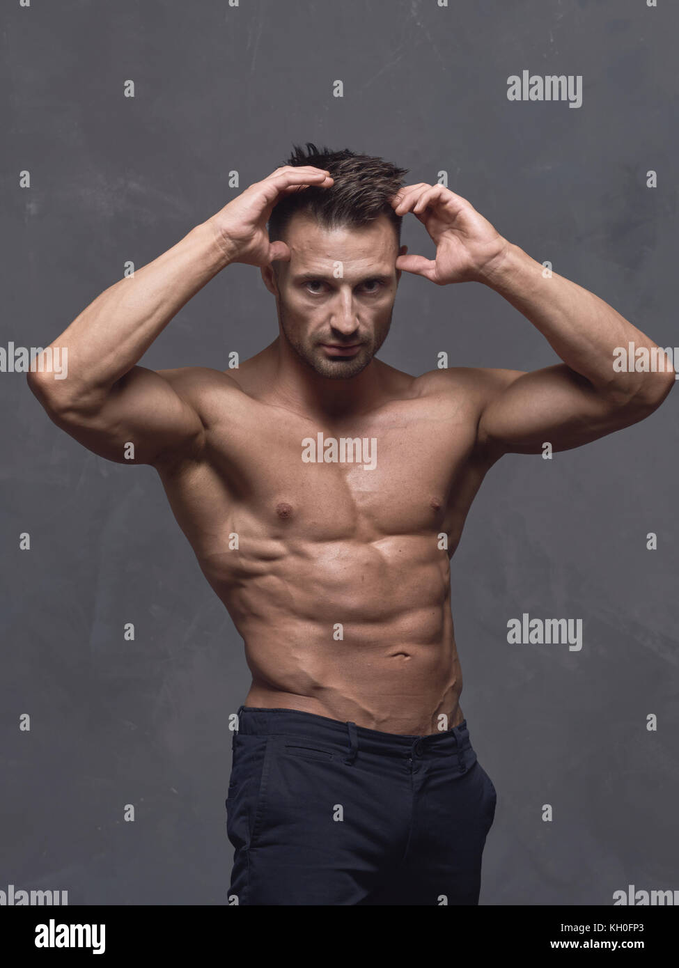 A Black Haired Man With A Short Haircut Is Standing Near The
