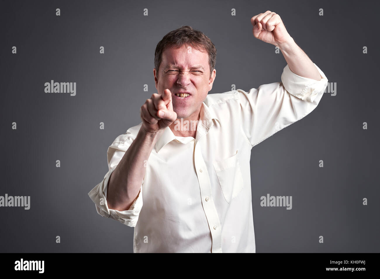Portrait of a angry middle age man getting fury Stock Photo