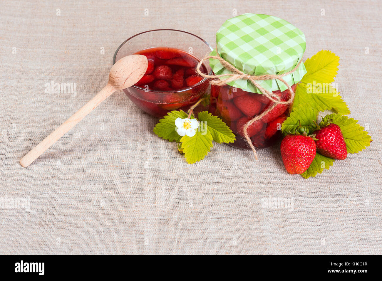 Fresh red strawberry and jam on textile background Stock Photo - Alamy