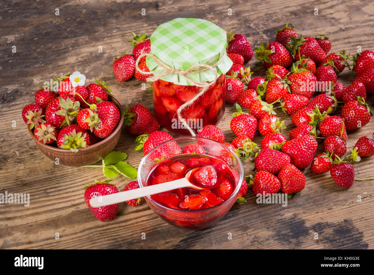 Fresh red strawberry and jam on wood background Stock Photo - Alamy