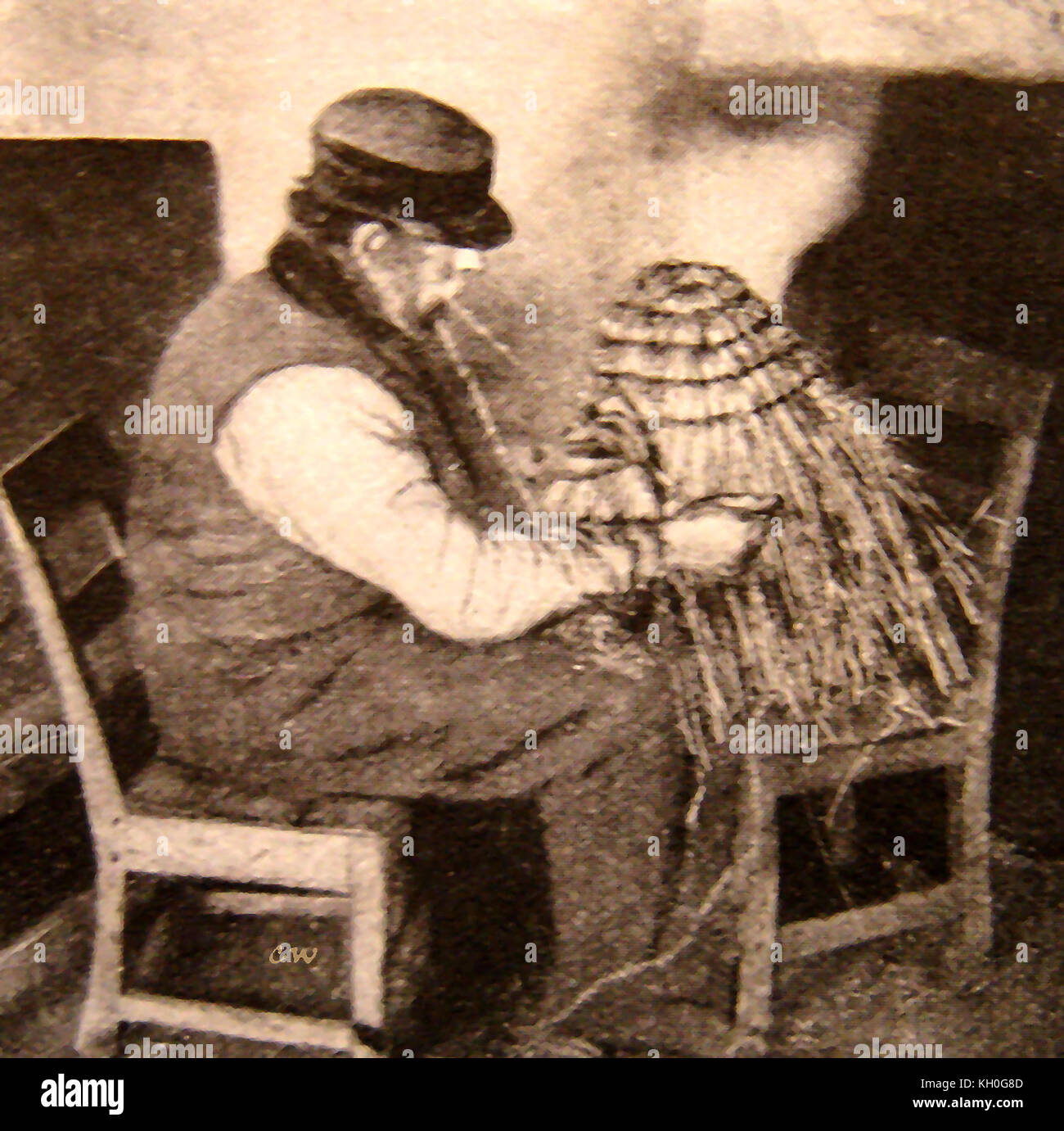 Straw Hat - A man in France with his lap dogs wears the typical straw hat popular in the early 1900's Stock Photo