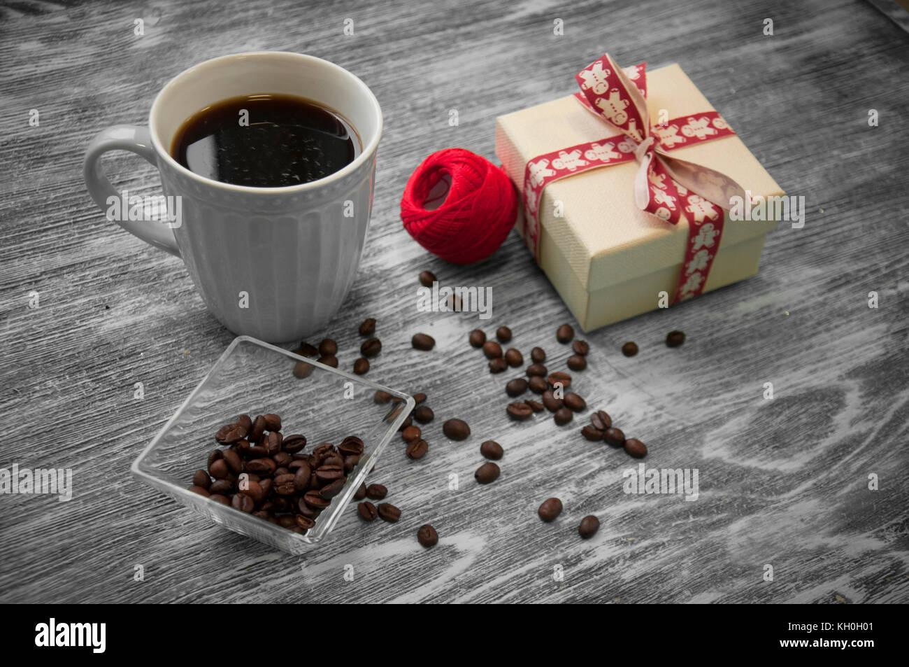 hank of threads, gift box, coffee beans and cup of cofee on gray Stock Photo