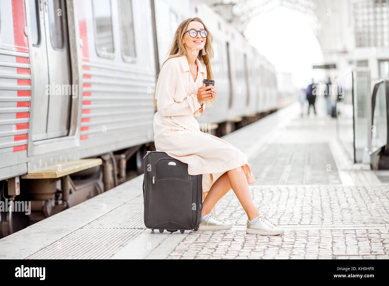 Young woman sitting platform train hi-res stock photography and images ...