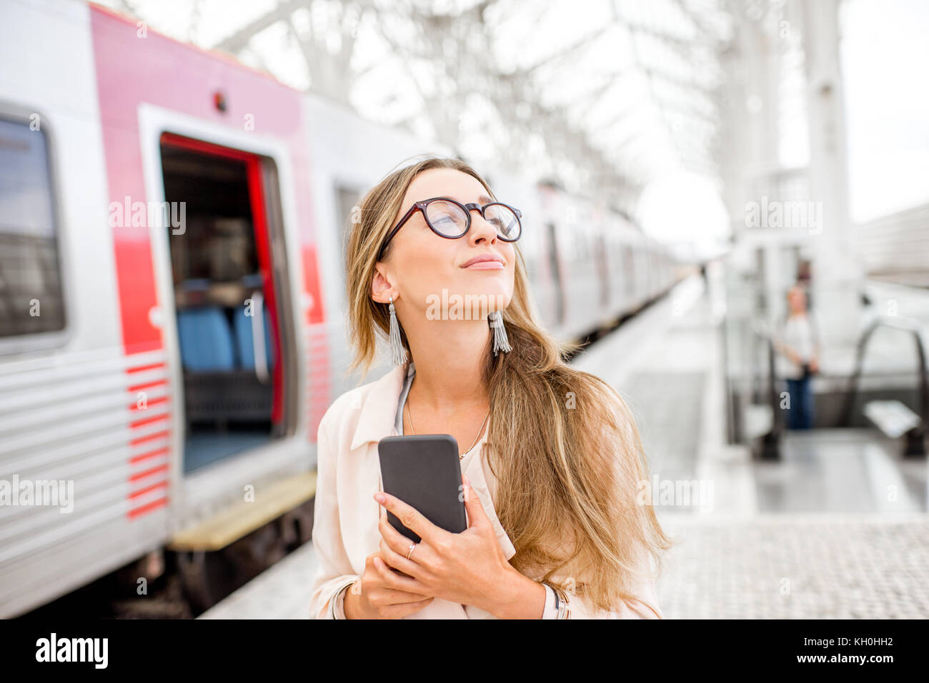 Woman at the railway station Stock Photo - Alamy