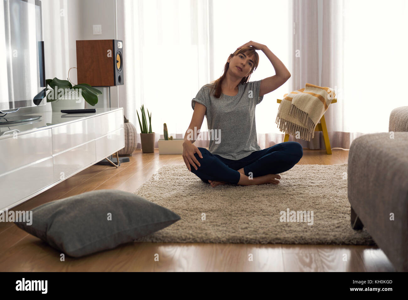 Full length shot of a woman doing exercise at home Stock Photo - Alamy