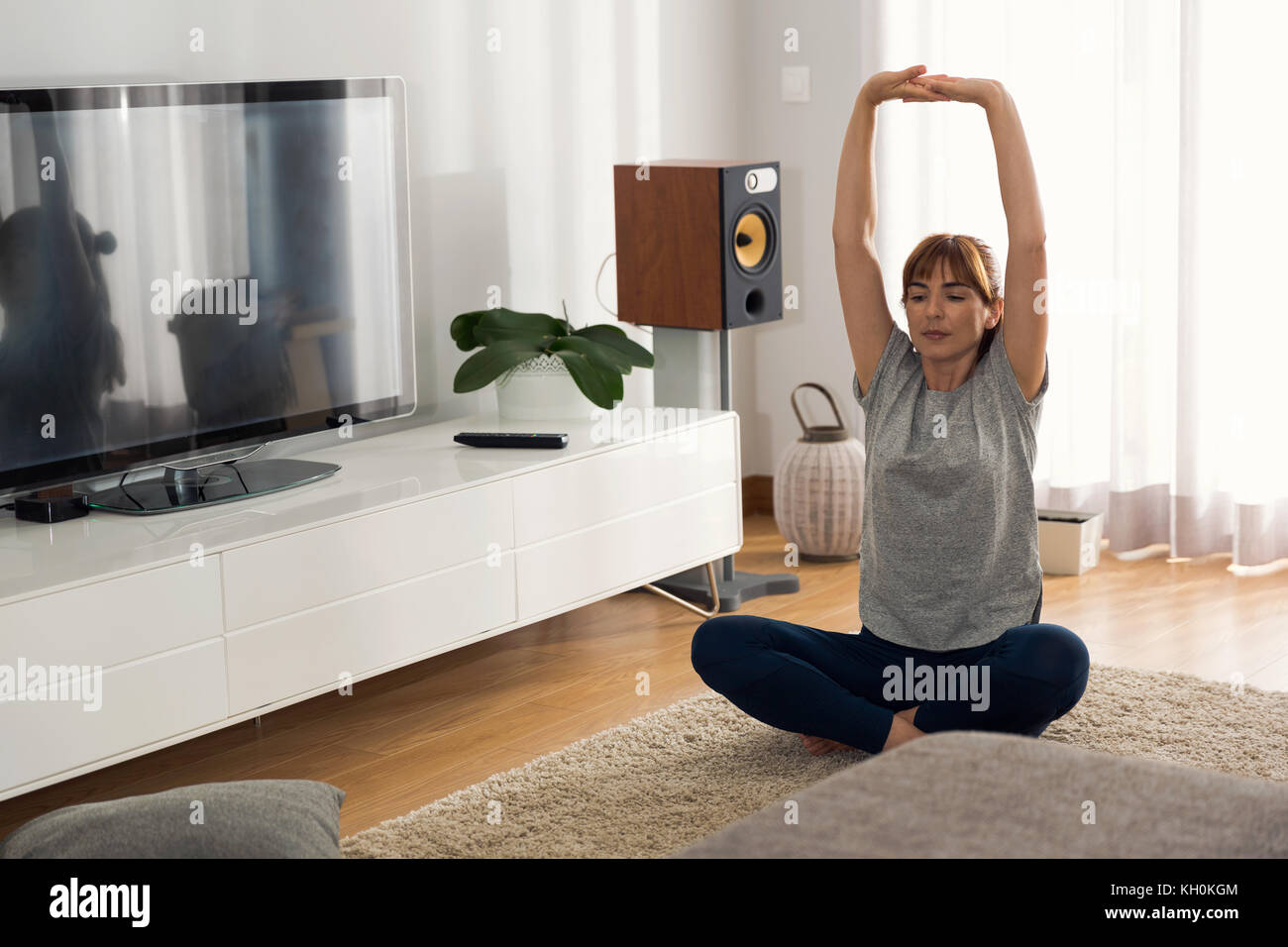 Full length shot of a woman doing exercise at home Stock Photo - Alamy