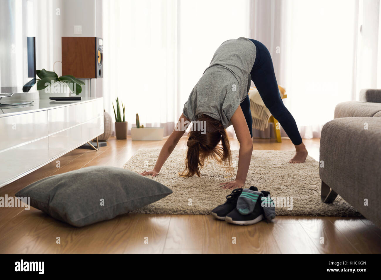 Full length shot of a woman doing exercise at home Stock Photo - Alamy