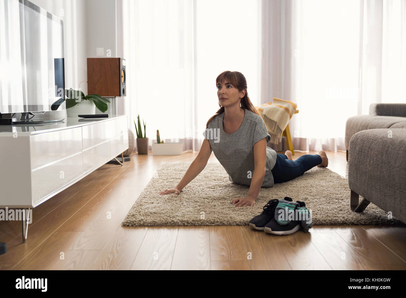 Full length shot of a woman doing exercise at home Stock Photo - Alamy