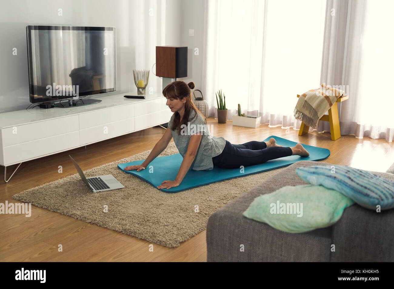 Full length shot of a woman doing exercise at home Stock Photo - Alamy