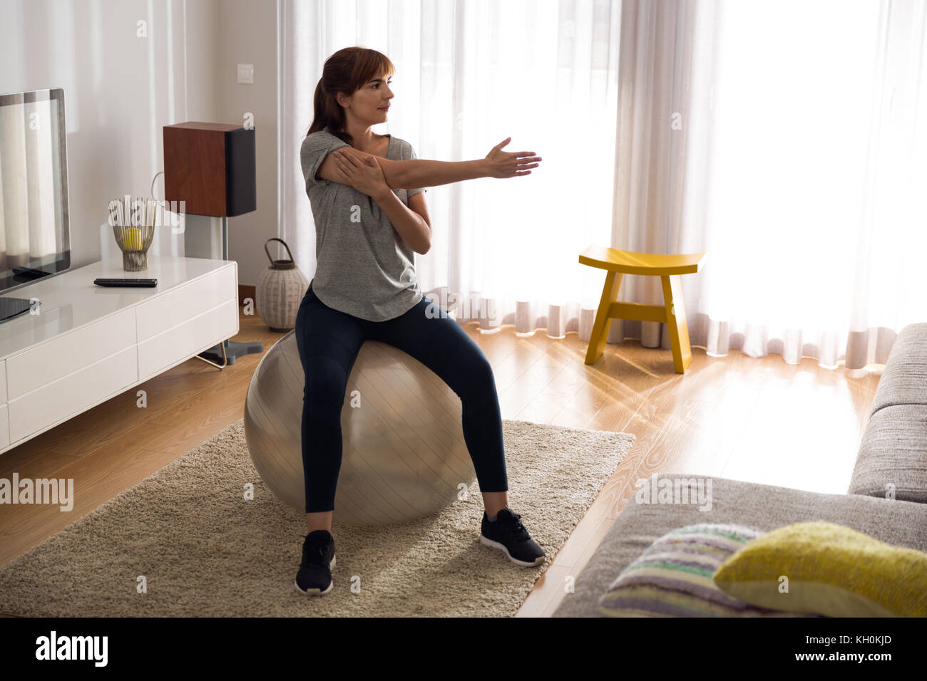 Full length shot of a woman doing exercise at home Stock Photo - Alamy