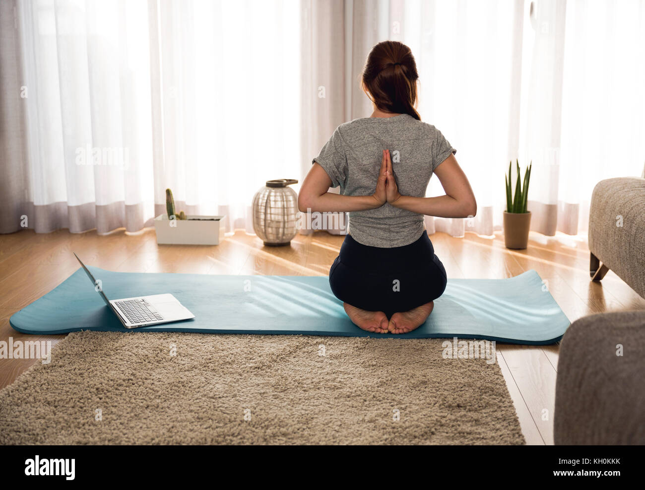 Full length shot of a woman doing yoga at home Stock Photo - Alamy