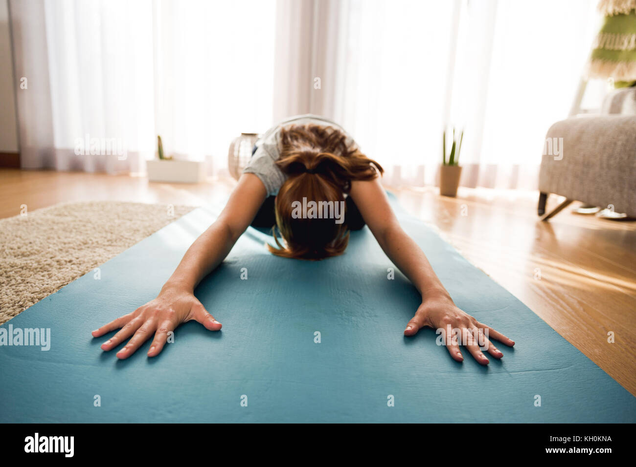Full length shot of a woman doing exercise at home Stock Photo - Alamy