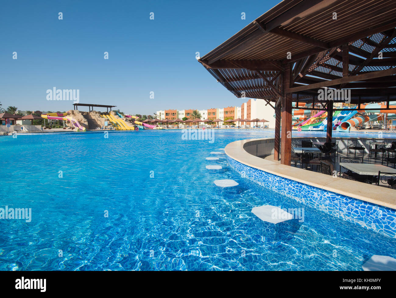 Picture of Large swimming pool with bar and aqua park water slides at a luxury ...