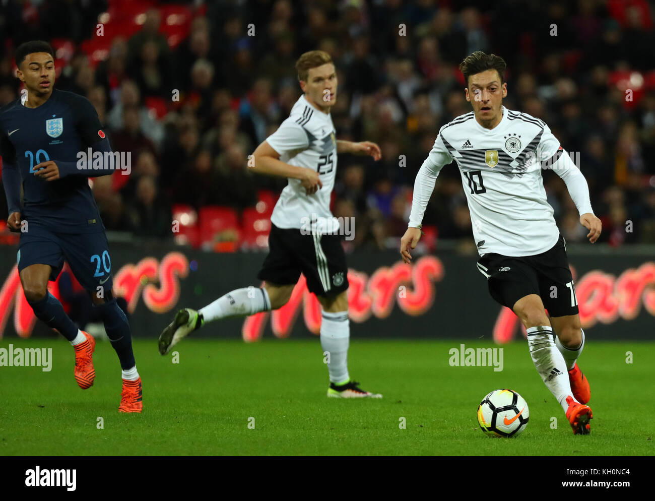 London, Great Britain. 10th Nov, 2017. Germany's Mesut Ozil (R) and Marcel Halstenberg (C) vying for the ball against England's Jesse Lingard during the international soccer match between England and Germany at Wembley stadium in London, Great Britain, 10 November 2017. Credit: Christian Charisius/dpa/Alamy Live News Stock Photo