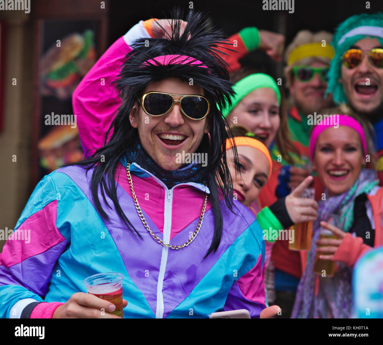 Cologne, Germany, 11 Nov, 2017, Cologne traditionally opens the carnival season Nov. 11th every year. People dressed up and went outside despite the rainy weather. Picture shows a group of people dressed in 70's clothes with a great big smile, Detlef Herklotz / Alamy Live News Stock Photo