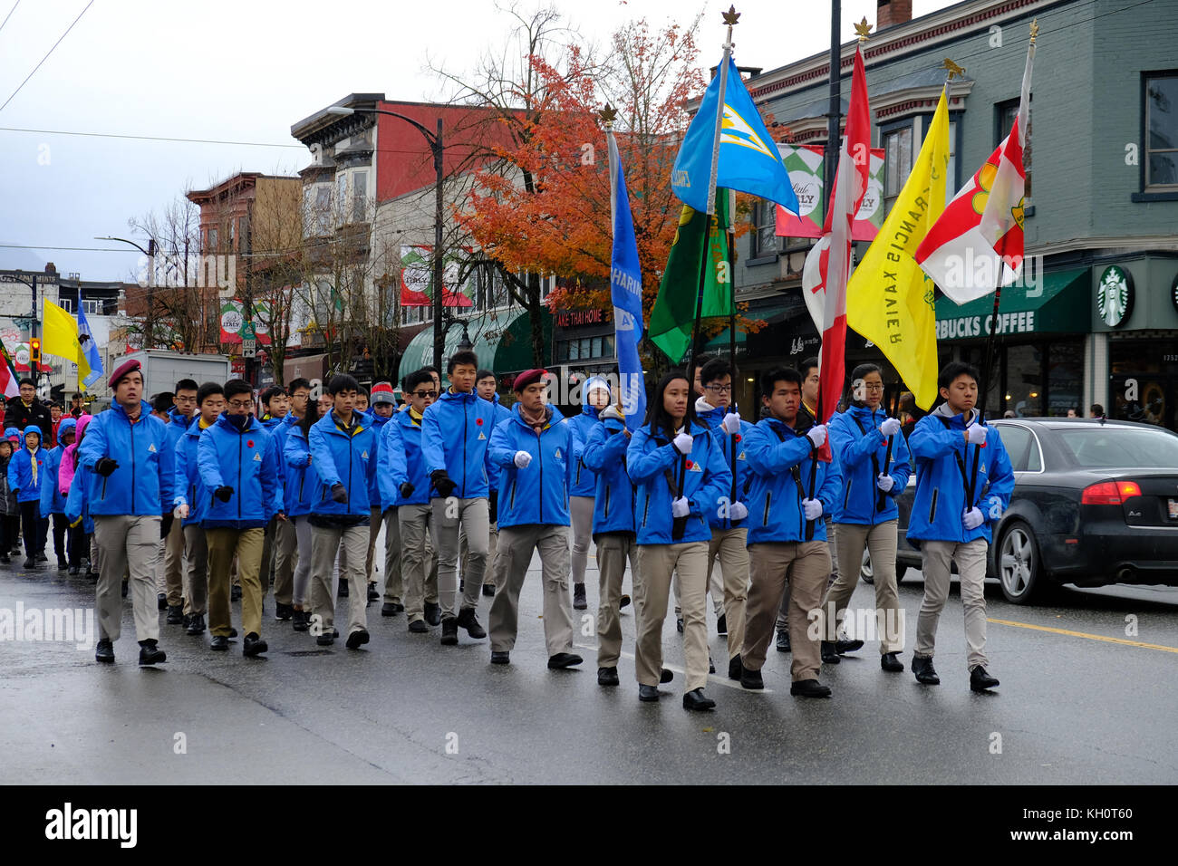 War veterans and supporters march down Commercial Drive near Grand View Park, carrying flags for remembrance day November 11th, 2017 in Vancouver City, Canada Stock Photo