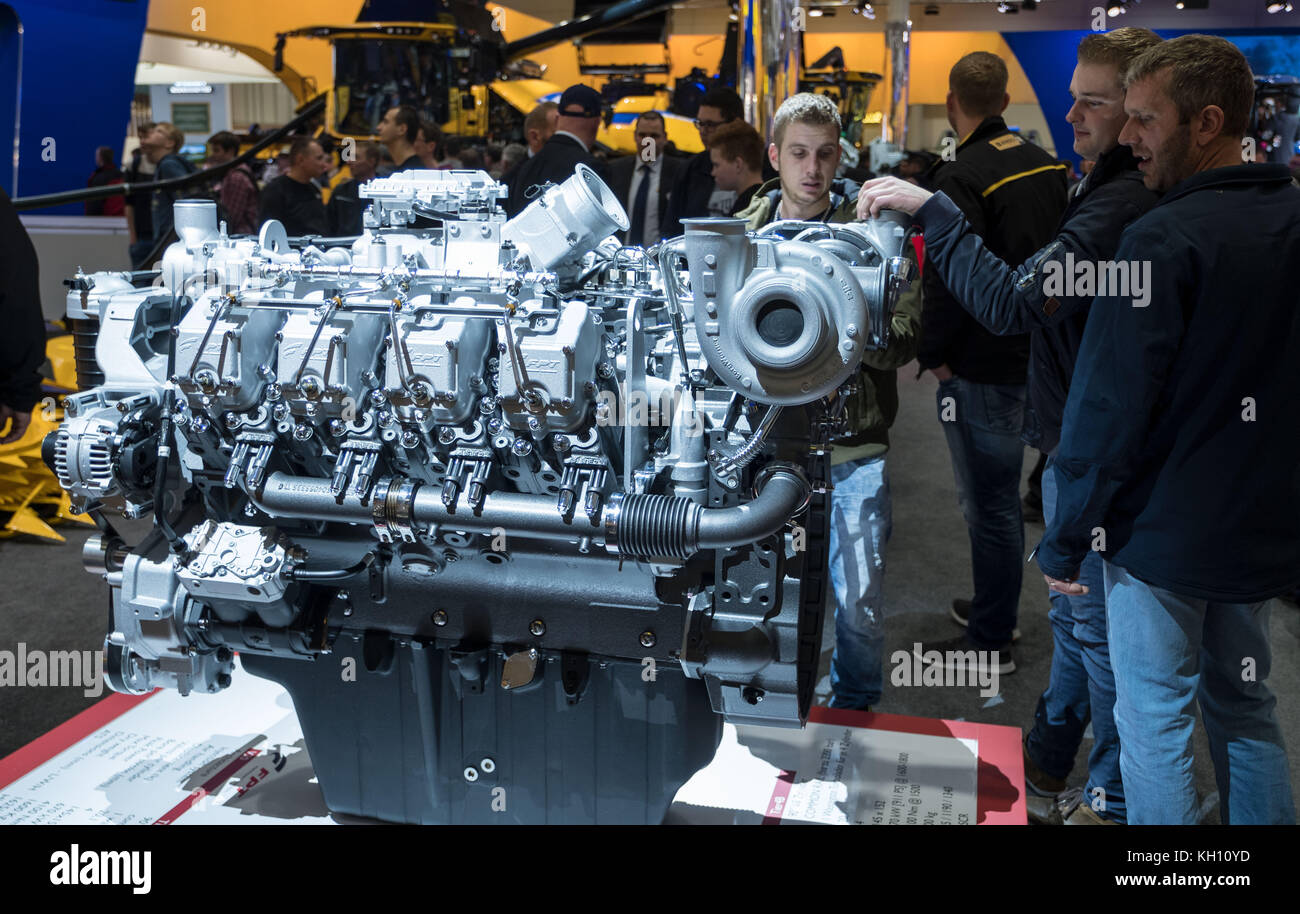 Hanover, Germany. 12th Nov, 2017. Visitors look at a Turbo Motor V8 tractor by the company FPT at the agricultural engineering fair Agritechnica in Hanover, Germany, 12 November 2017. About 2800 exhibitors from 53 countries are expected at the fair, which is taking place until 18 November 2017. Credit: Peter Steffen/dpa/Alamy Live News Stock Photo