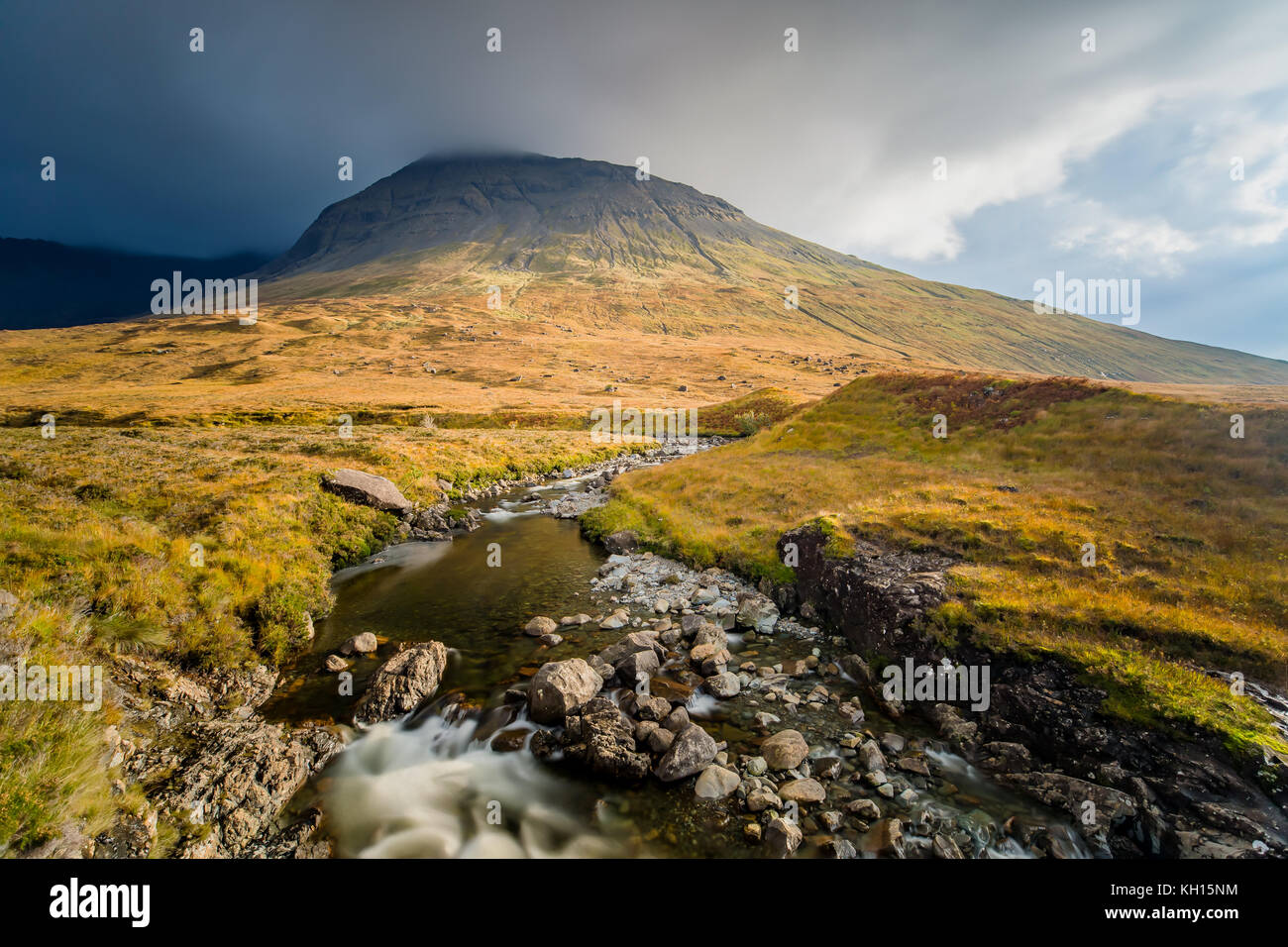 The Sun shines on the Mountains at Fairy Pools on Isle of Skye Stock Photo