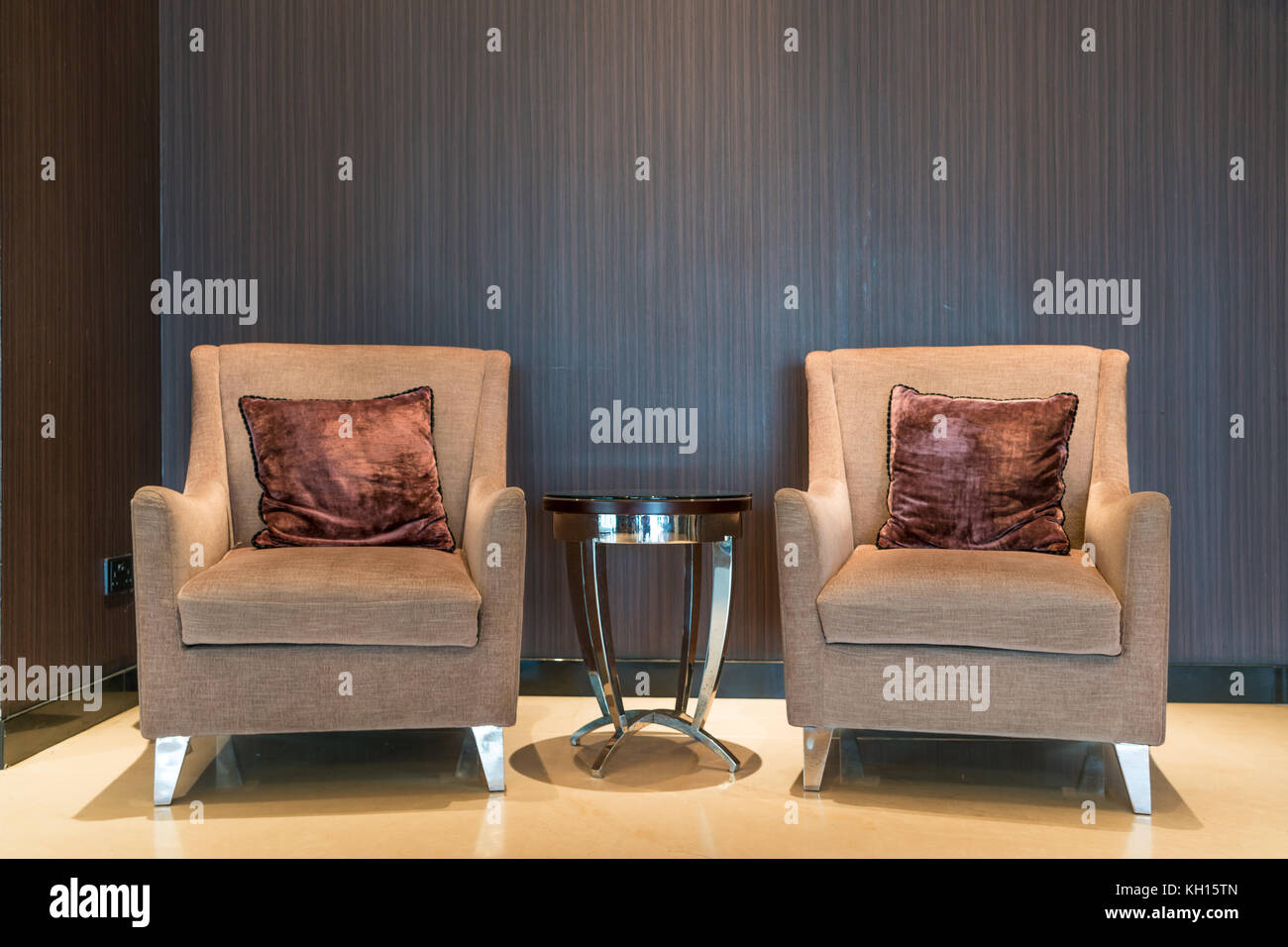 Leather armchair and coffee table in lobby at hotel. Interior design of